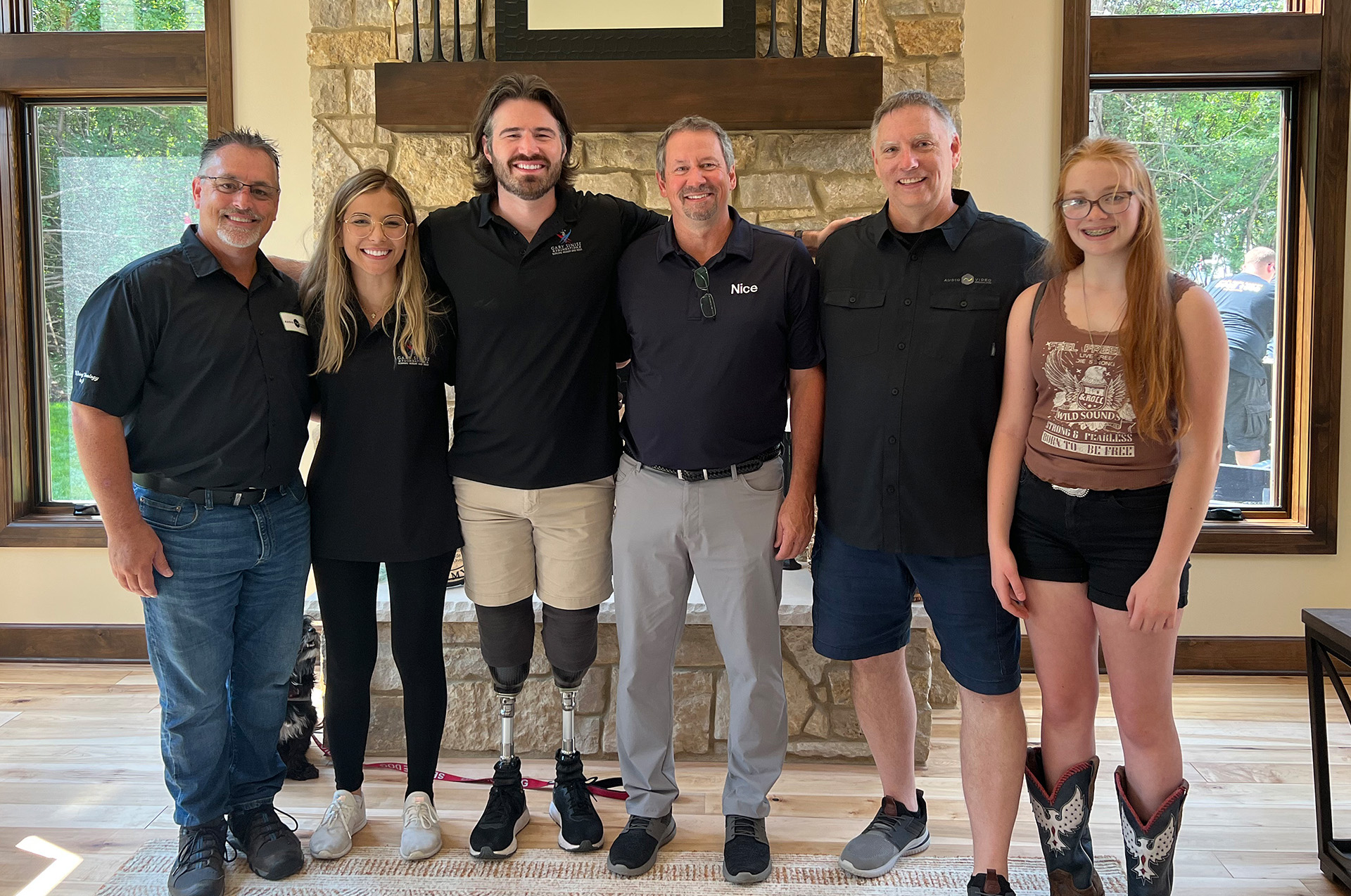 Capt. Jason Church and his family with the Gary Sinise Foundation team and Audio Video Specialists at the completed home unveiling
